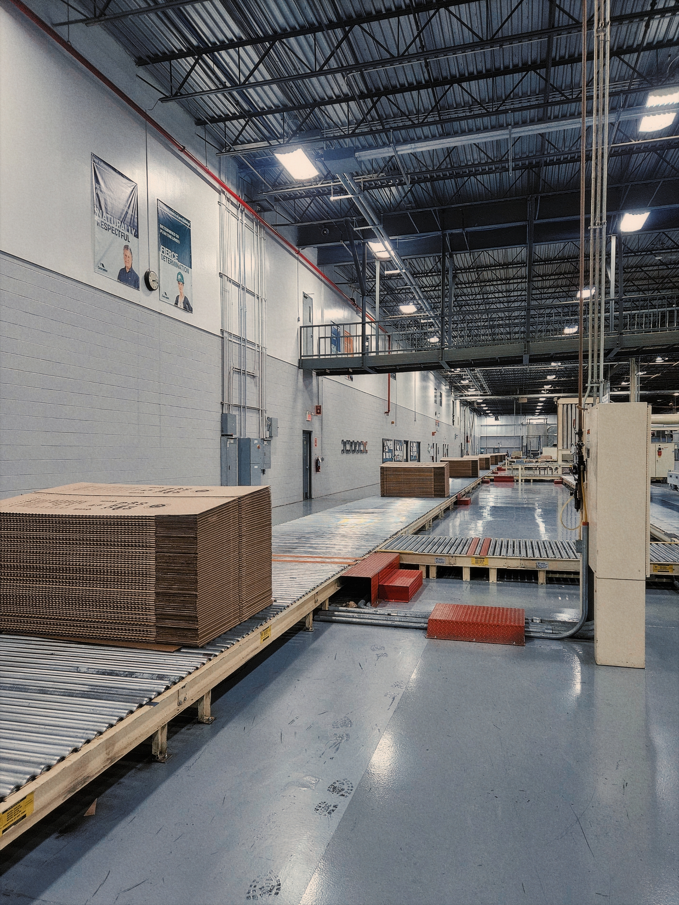 Corrugated cardboard moving down a conveyor belt.