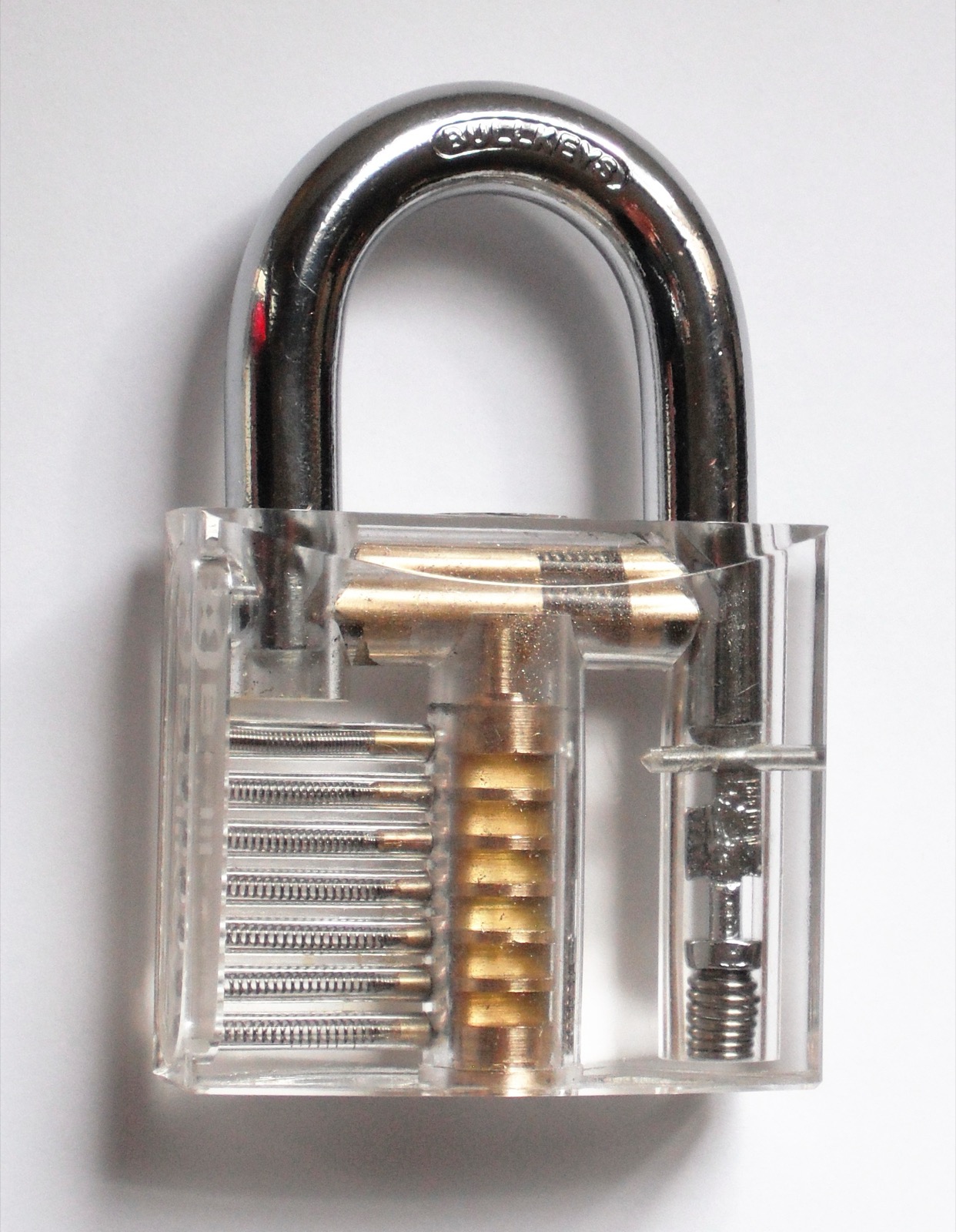 A transparent padlock photographed closed, used as a visual metaphor for trusted workflow gates.