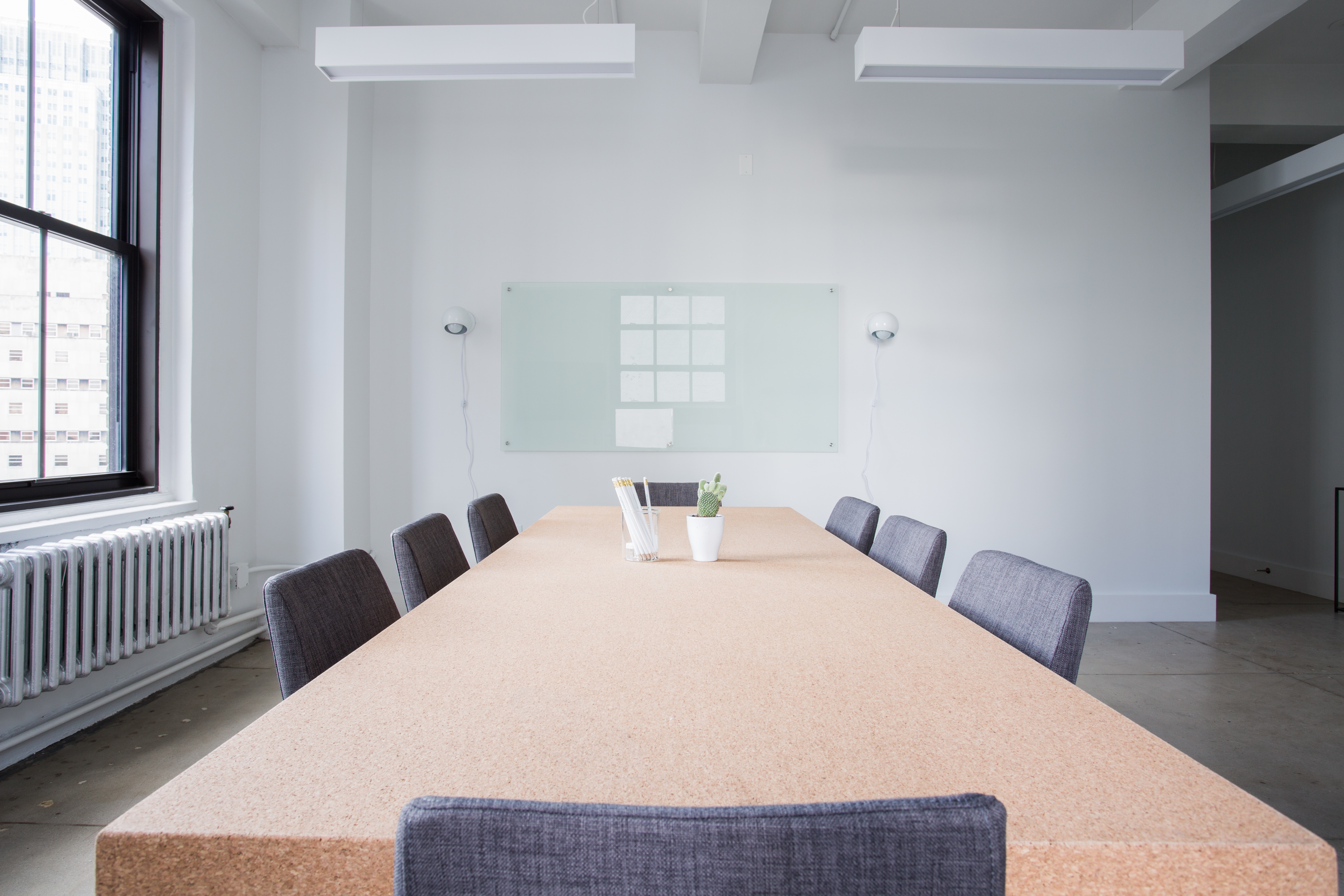 Conference room table surrounded by empty chairs.